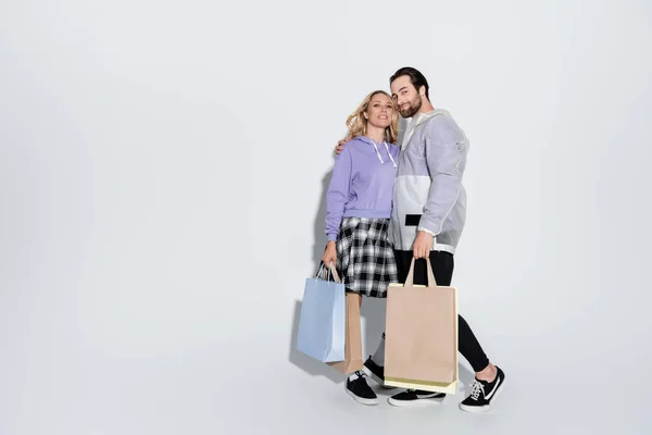 Full Length Happy Man Blonde Woman Tartan Skirt Holding Shopping — Fotografia de Stock