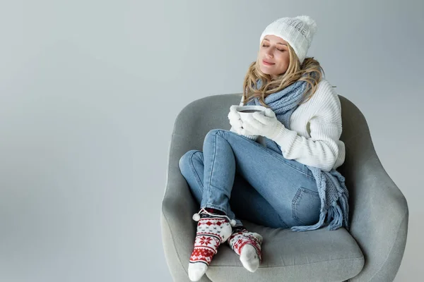 Cheerful Blonde Woman Winter Outfit Sitting Armchair Holding Cup Coffee — 스톡 사진