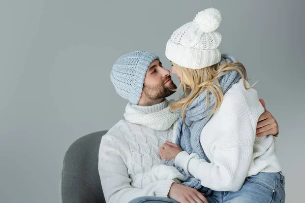 Blonde Woman Winter Hat Knitted Scarf Looking Bearded Boyfriend Armchair — Stok fotoğraf