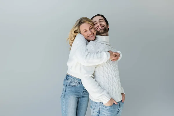 Cheerful Woman Hugging Man White Sweater Posing Hands Pockets Isolated — Stock Fotó