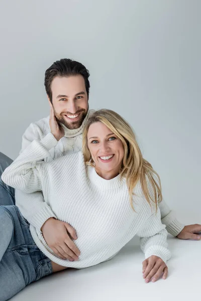 Happy Man Woman White Knitted Sweaters Looking Camera Grey — Stok fotoğraf