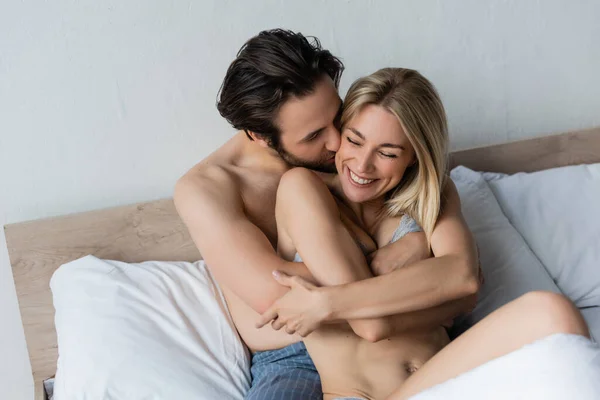 Brunette Man Embracing Seductive Blonde Woman Smiling Closed Eyes Bedroom — Stok fotoğraf