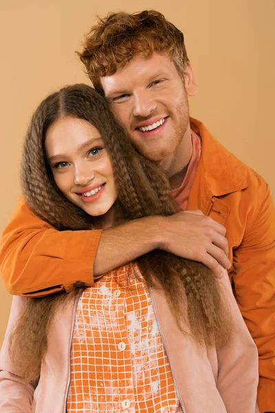 Cheerful Young Redhead Man Hugging Happy Girlfriend Wavy Hair Isolated — Stockfoto
