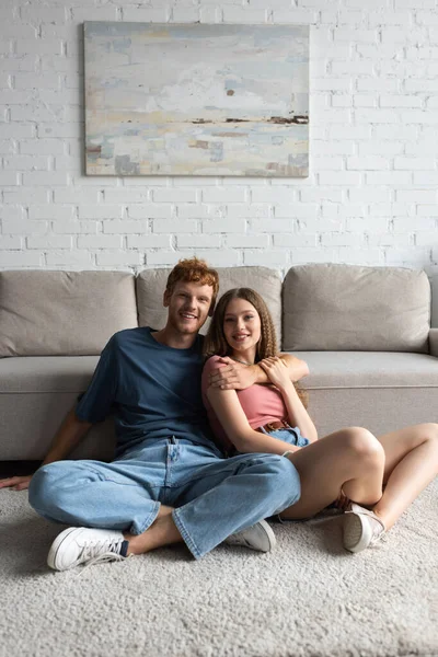 Redhead Happy Young Man Hugging Pretty Girlfriend Living Room — Stok Foto