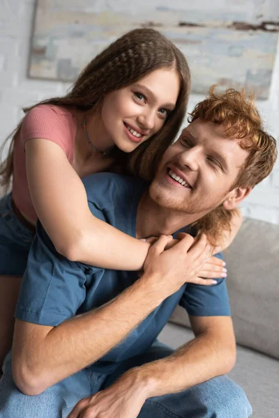 Happy Teen Girl Smiling Hugging Redhead Boyfriend Living Room — Stok fotoğraf