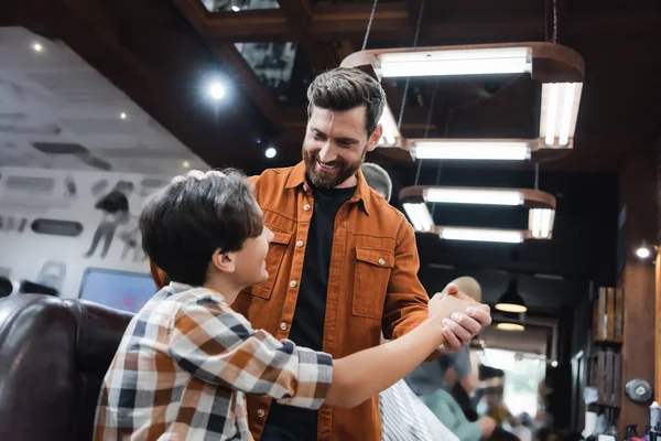 Smiling Bearded Barber Holding Hand Teenage Client Barbershop — Stock Photo, Image