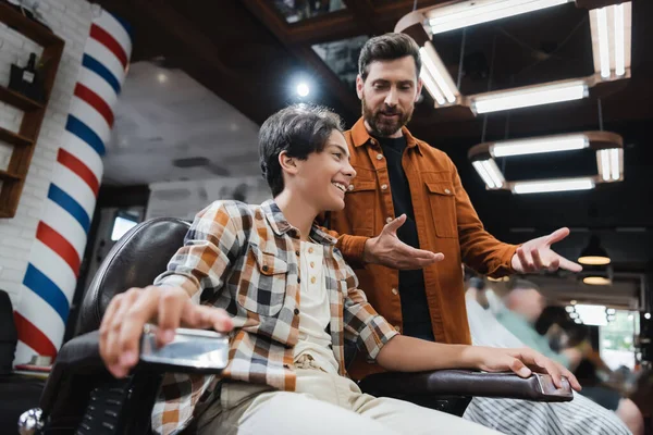 Low Angle View Smiling Teenage Client Sitting Armchair While Barber — Stock Photo, Image