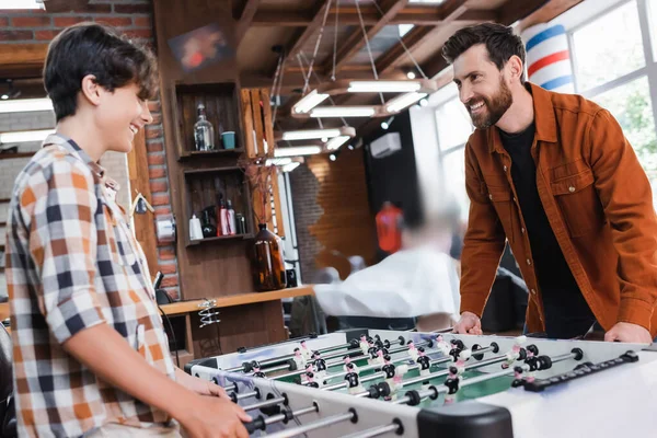 Cheerful Man Playing Table Football Son Barbershop — Stock Photo, Image