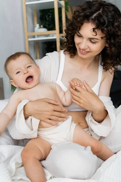 Smiling Mother Looking Baby Daughter Yawning Bed Home — Stock Photo, Image