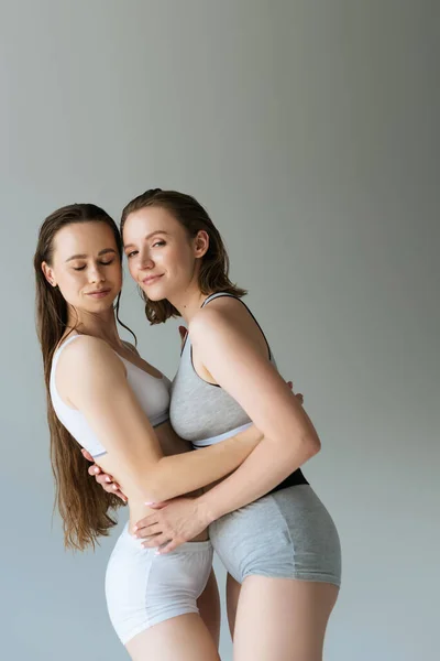 Young Lesbian Woman Underwear Embracing Brunette Girlfriend Looking Camera Isolated — Stock Photo, Image