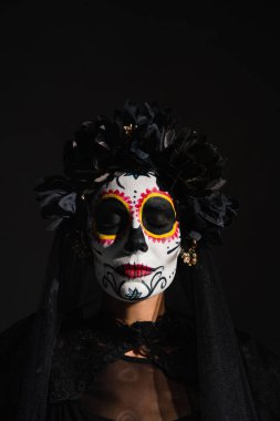 portrait of woman with closed eyes in scary catrina makeup and dark wreath isolated on black clipart