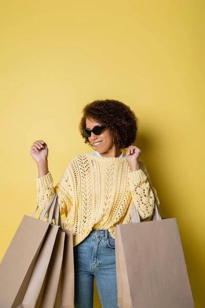 Cheerful African American Woman Sunglasses Holding Shopping Bags Yellow — Stock Photo, Image