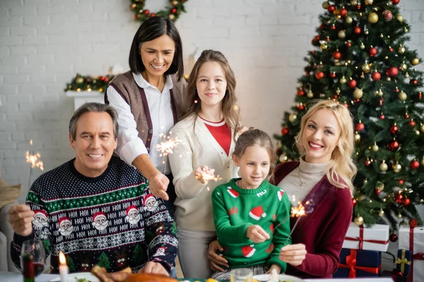 Cheerful Girls Mother Interracial Grandparents Holding Sparklers Decorated Christmas Tree — Stock Photo, Image