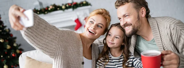 Smiling Woman Taking Selfie Daughter Husband Holding Cup New Year — Stock Photo, Image