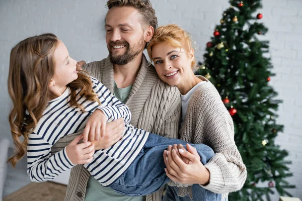 Smiling Parents Warm Cardigans Holding Daughter New Year Celebration Home — Stock Photo, Image