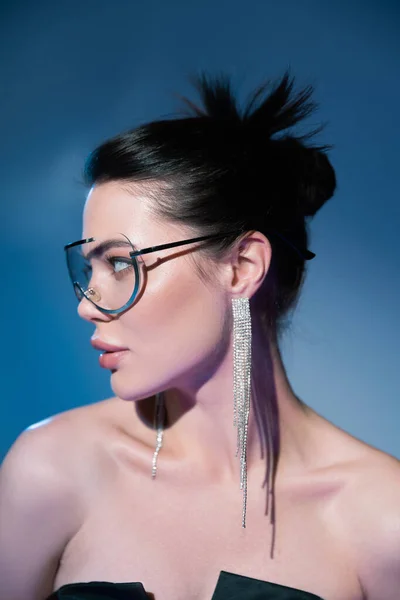 Portrait Brunette Woman Fashionable Transparent Eyeglasses Looking Away Blue Background — Stock Photo, Image
