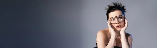 Elegante Donna Bruna Occhiali Sole Che Tocca Viso Sfondo Grigio — Foto Stock