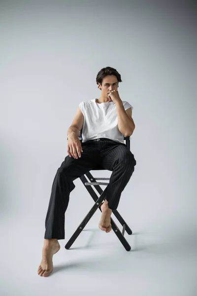 Full Length Barefoot Man Striped Trousers White Shirt Sitting Camp — Stock Photo, Image