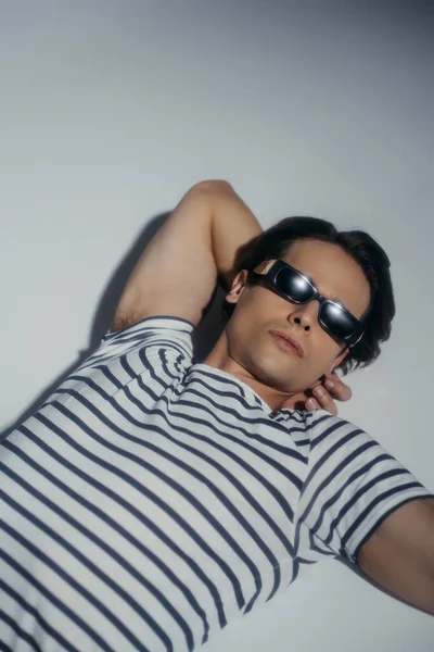 High Angle View Stylish Man Sunglasses Striped Shirt Lying Grey — Stock Photo, Image