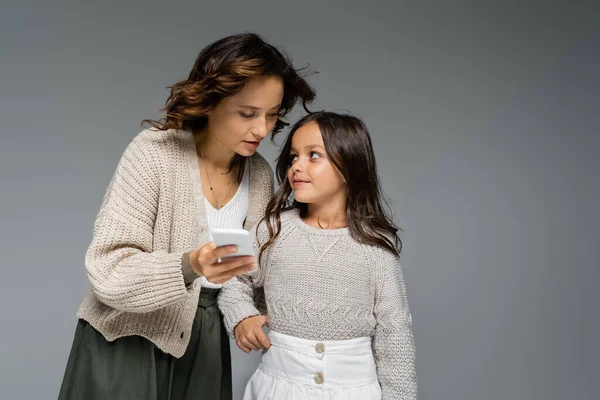 Smiling Girl Stylish Autumn Clothes Looking Mom Smartphone Isolated Grey — Stock Photo, Image