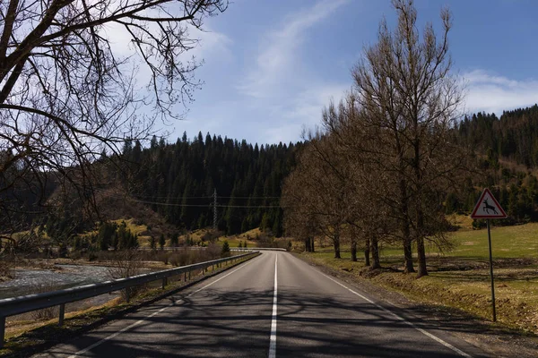 Road sign with mountain and sky at background — Stock Photo