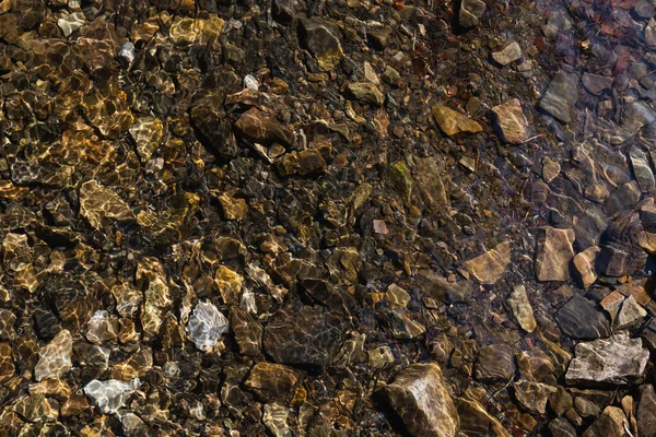 Top view of stones on shallow bottom of lake — Stock Photo