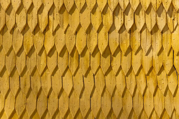 Ornament of yellow wooden roof at daytime — Stock Photo
