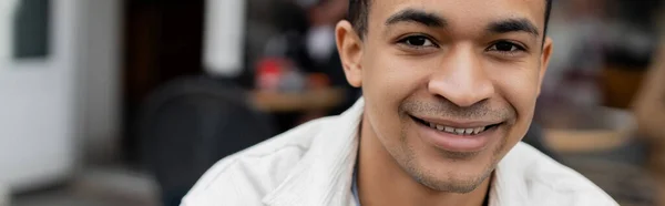 Portrait of cheerful african american man looking at camera, banner — Stock Photo