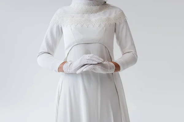 Cropped view of bride in gloves and wedding dress isolated on grey — Stock Photo