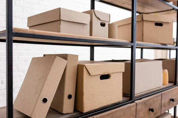 Different carton packages on rack in donation center — Foto stock