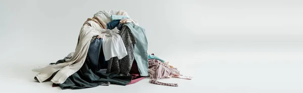 Mess of different clothes on grey background with copy space, banner — Fotografia de Stock