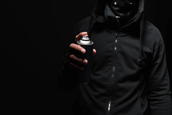 Cropped view of african american bandit with scarf on face holding spray paint isolated on black — Stock Photo