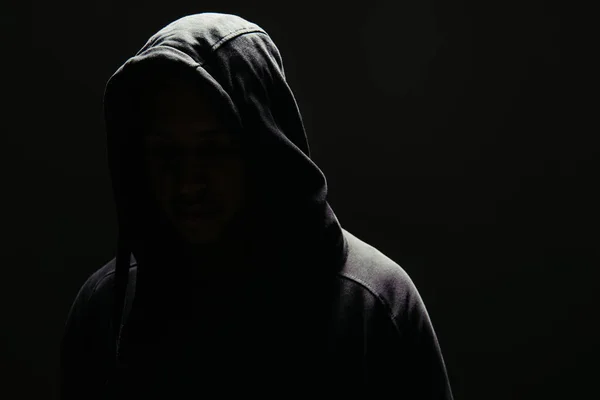 Silhouette of hooligan in hoodie isolated on black — Foto stock