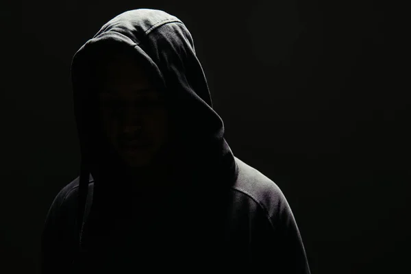 Silhouette of hooligan in hoodie isolated on black — Stock Photo