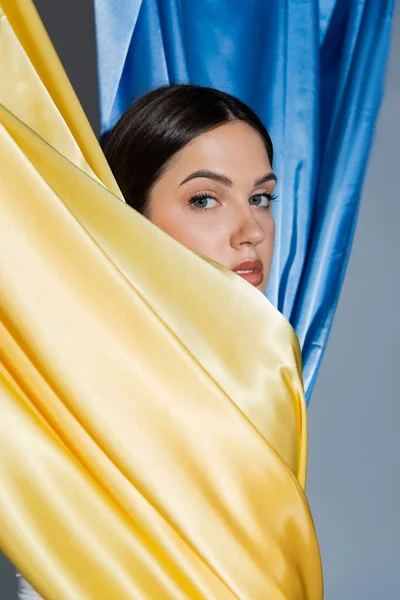 Porträt einer sinnlichen jungen Ukrainerin, die in der Nähe der blau-gelben Nationalflagge posiert — Stockfoto