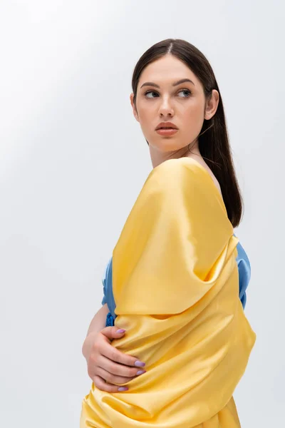 Sensual young ukrainian woman in yellow and blue clothing posing isolated on grey — Stock Photo