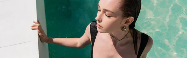 Top view of young woman in stylish swimsuit swimming in pool, banner — Photo de stock