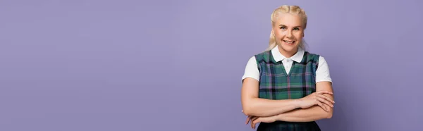 Cheerful student in shirt and vest looking at camera isolated on purple, banner — Stockfoto