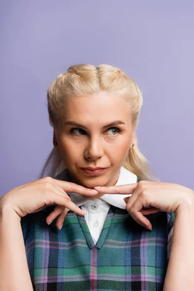 Portrait of pensive blonde student looking away isolated on purple — стоковое фото