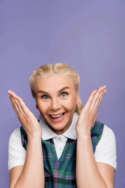 Astonished student in shirt and vest looking at camera isolated on purple — стоковое фото