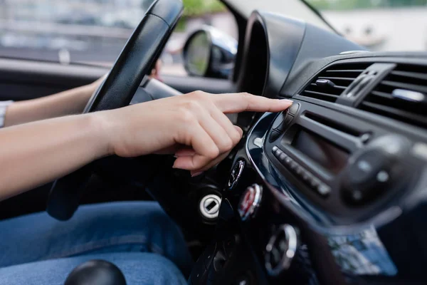 Cropped view of woman pushing button on control panel in auto — Stock Photo