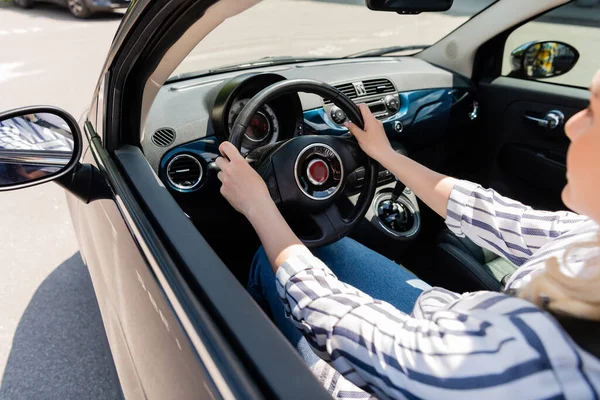 Blurred woman in casual clothes driving auto at daytime — Stock Photo