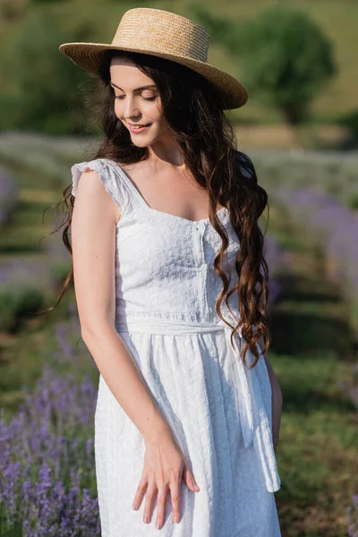 Romantic woman in white dress in blurred summer field — Foto stock