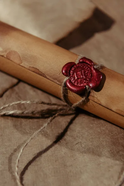 Top view of ancient manuscript stamped with wax seal on craft paper surface — Stock Photo