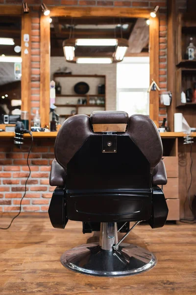 Armchair near blurred mirror in beauty salon — Stock Photo