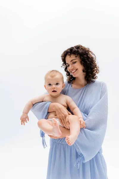 Pleased mother holding baby daughter isolated on white — Stock Photo