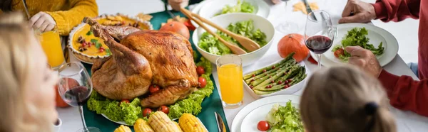 Overhead view of delicious turkey near dinner and family at home, banner — Stock Photo