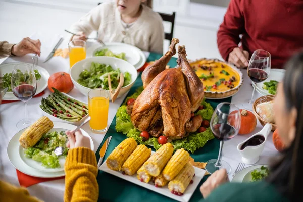 Delicious turkey and dinner near family celebrating thanksgiving at home — Stock Photo