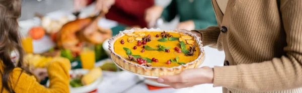 Cropped view of woman holding delicious thanksgiving pie at home, banner — Stock Photo