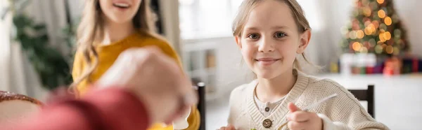 Smiling kid looking at camera during thanksgiving celebration with family at home, banner — Stock Photo